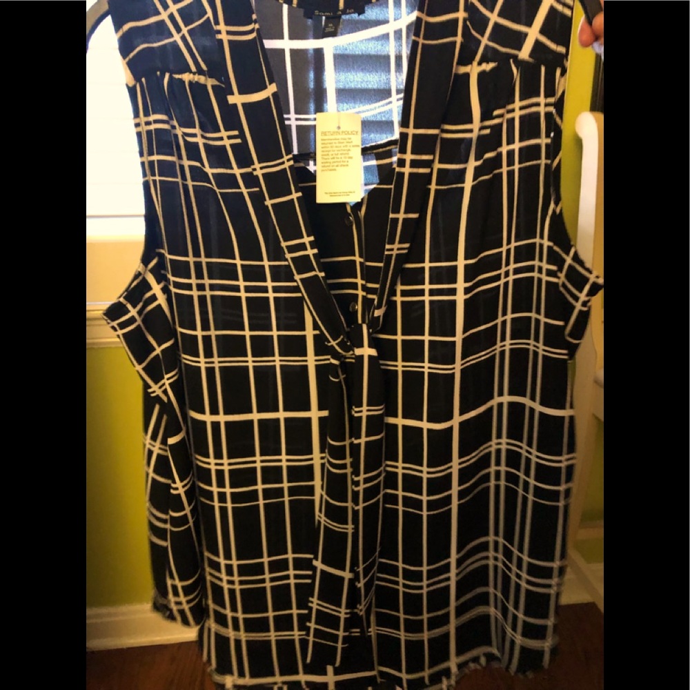 Black and white sleeveless tie blouse